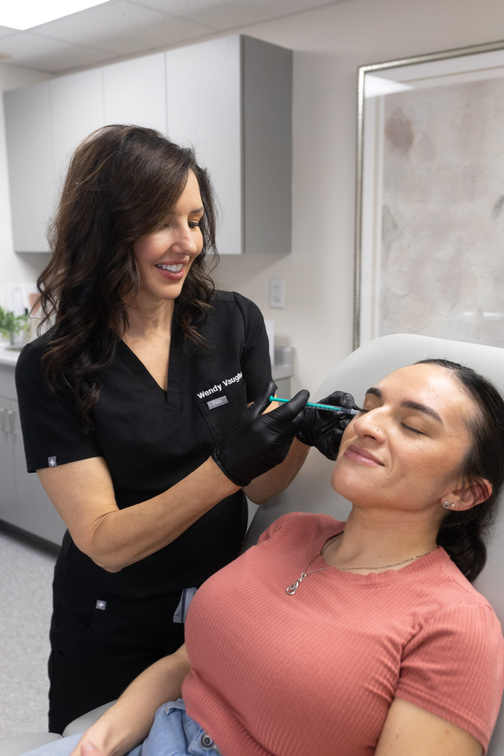 Photo of Wendy giving injectable treatments to a female patient